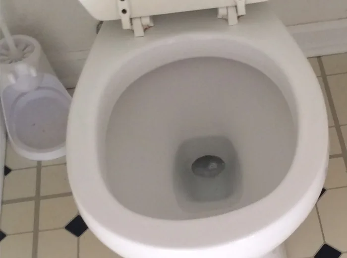 The same toilet clean, with the bathroom floor tiled and clear