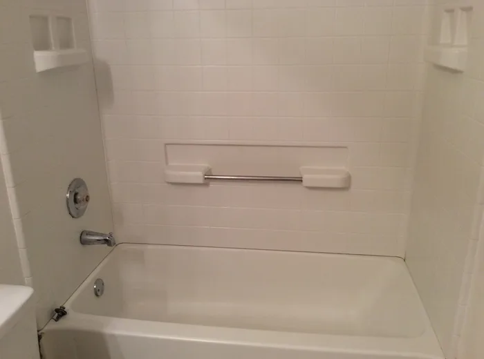 The same bathtub and surround after cleaning