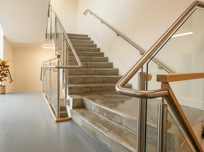 A commercial stairwell with clean handrails and steps